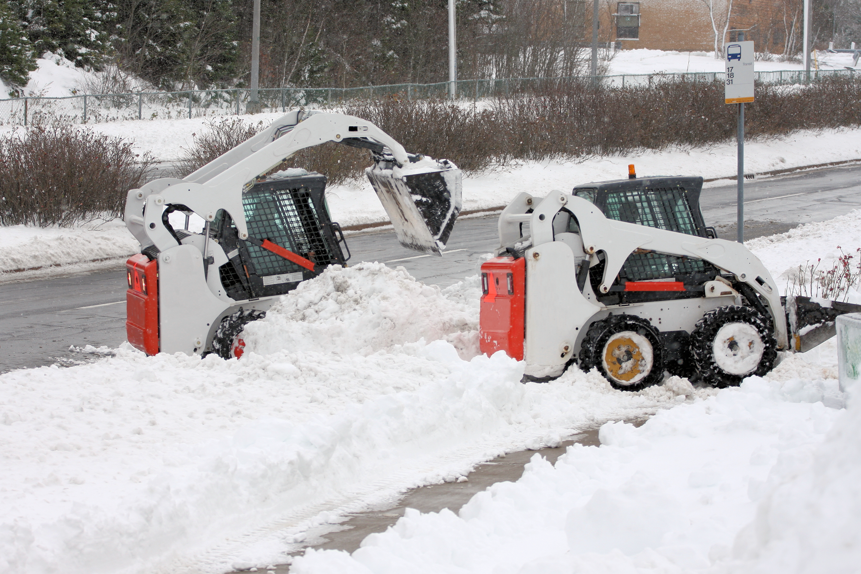 skid steer loader moving snow